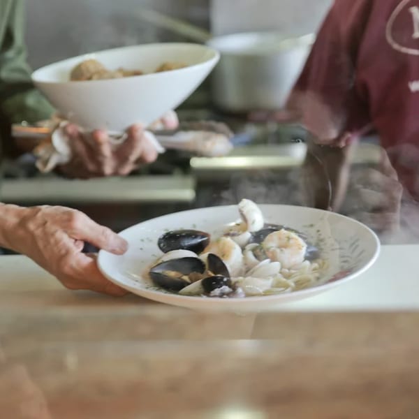 Steaming seafood pasta with mussels and shrimp being served at Mona Lisa Cucina.